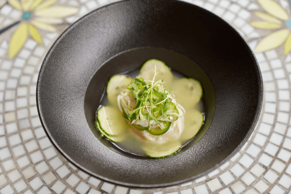Outdoor patio seating area with tables and umbrellas at La Posada Milford Hotel