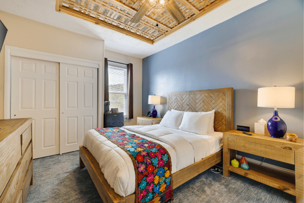 Cozy queen bed area in Deluxe Queen Room at La Posada Milford hotel